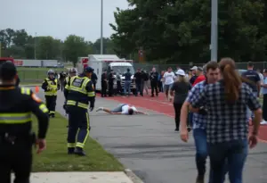 Police and emergency responders at the scene of a shooting near Forest Park High School.