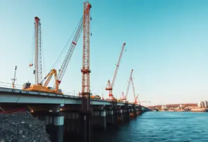 Crane lifting a test pile at Francis Scott Key Bridge construction site