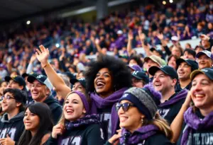 Fans in purple and black cheering for the Baltimore Ravens