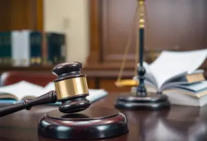 A gavel and legal documents representing fraud investigation