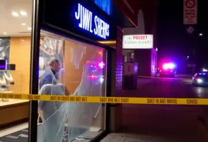 Scene of a jewelry store with broken glass following a burglary attempt.